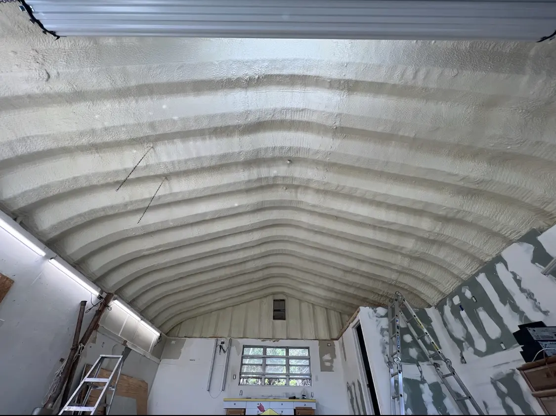 Spray polyurethane foam applied to the underside of a metal roof deck in Strasburg